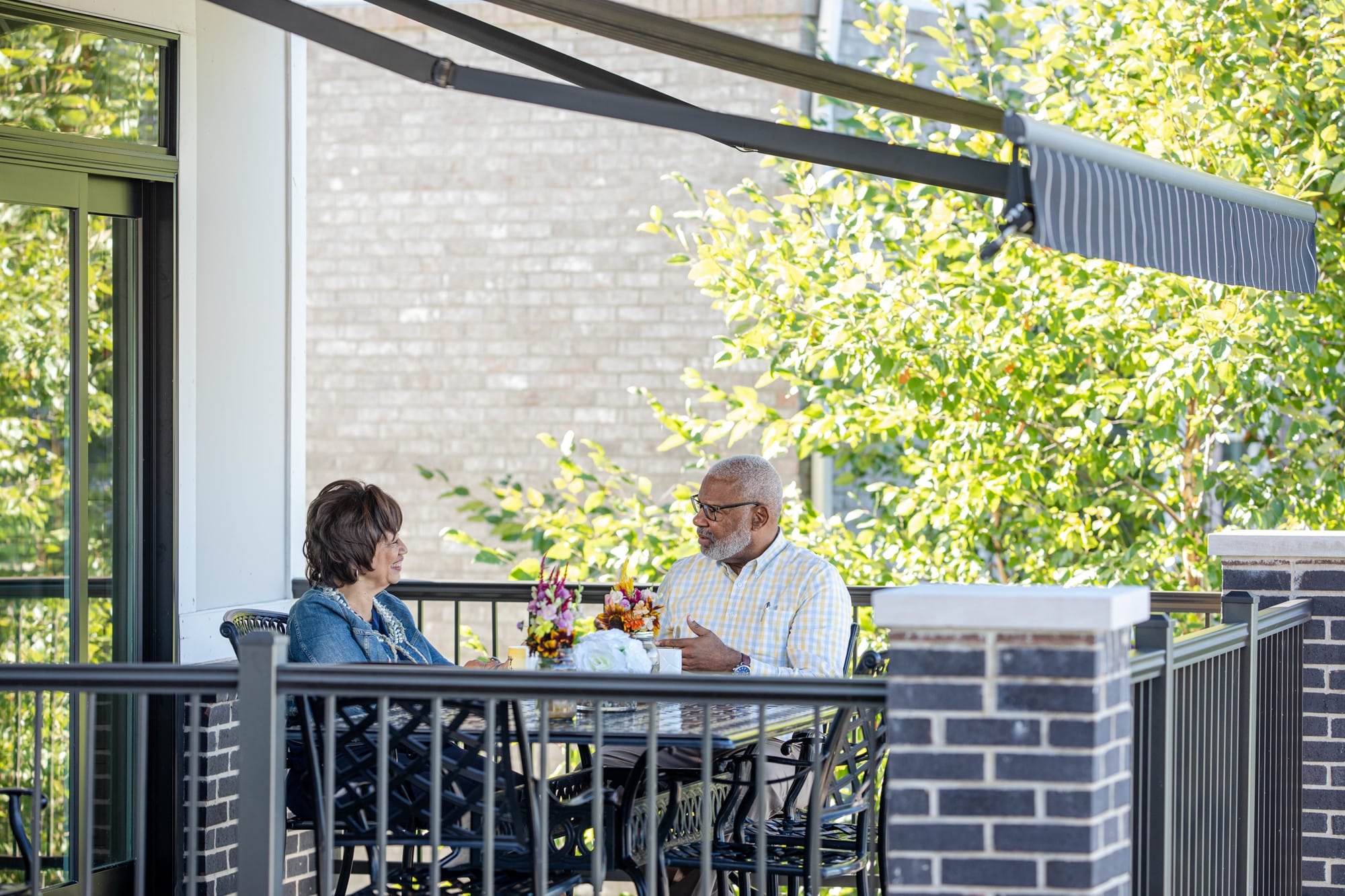 Couple Sitting Under a Retractable Awning