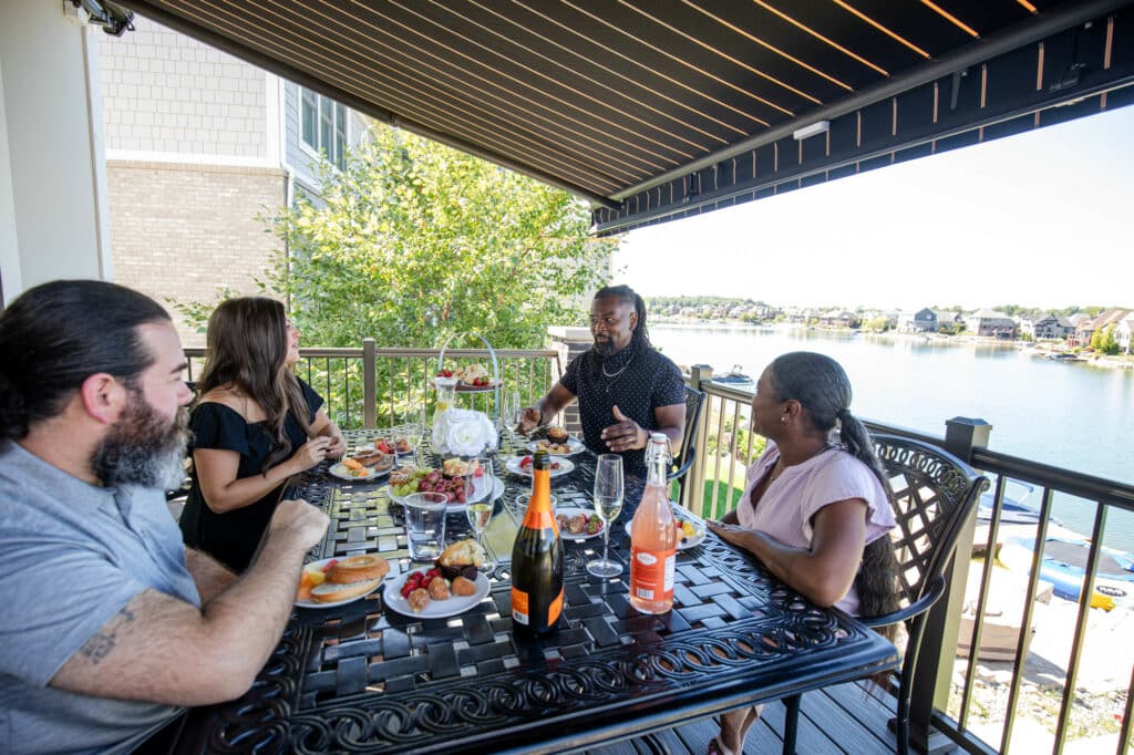 Friends enjoying food under an awning