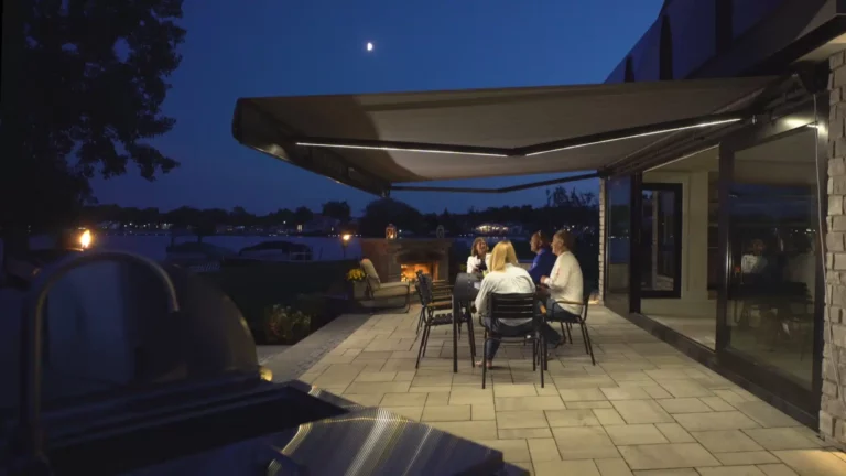 People sitting out at night underneath awning enjoying conversation