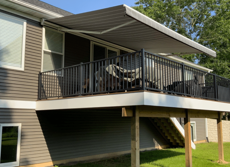 Beige and white retractable awning over deck in Massachusetts