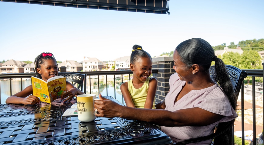 Mom with 2 kids enjoying relaxing under a retractable awning