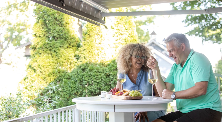 Couple sharing a laugh under a retractable awning