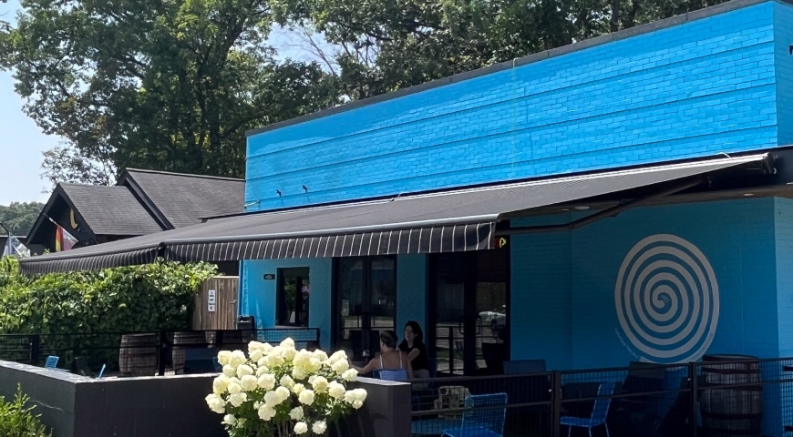 Awning extended over patio at restaurant providing shade coverage for diners.