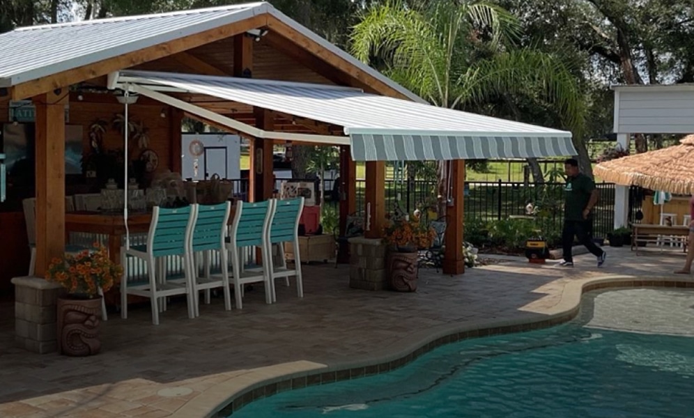 awning over top of pool bar with inground pool in background
