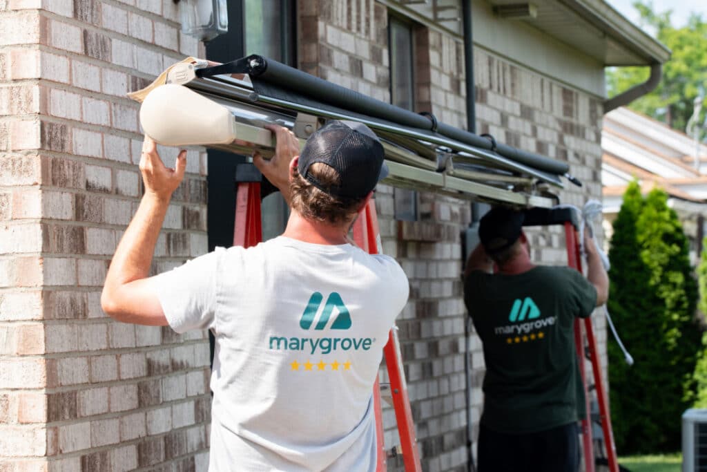 installation crew mounting awning at home renovation site