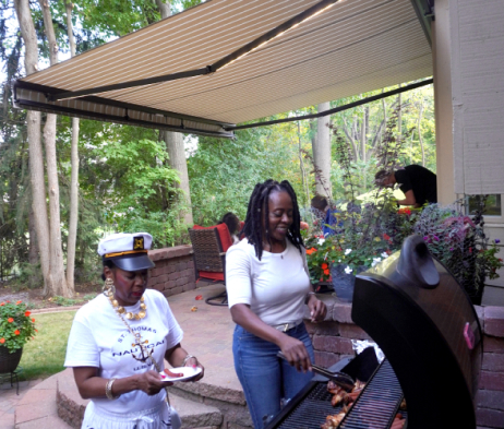 grill out next to backyard with awning extended