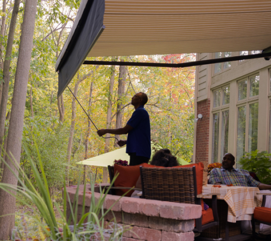 family underneath a retractable awning