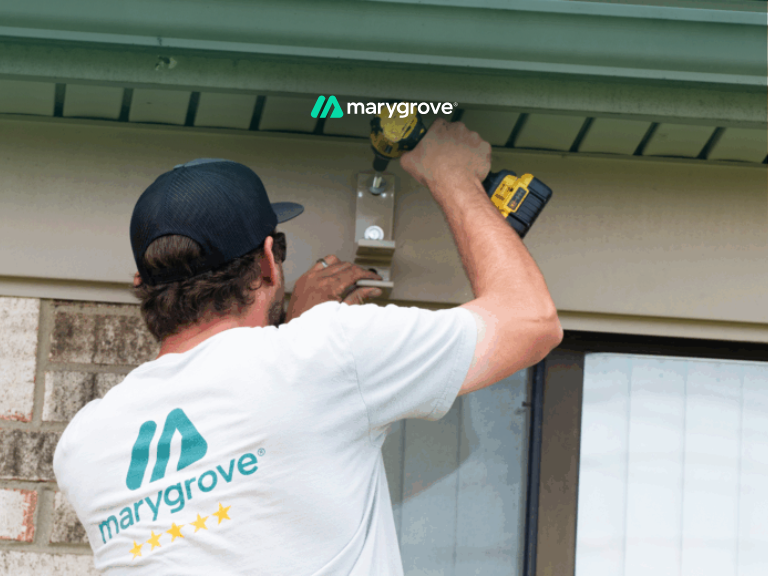 Man drilling into Stucco to mount retractable awning
