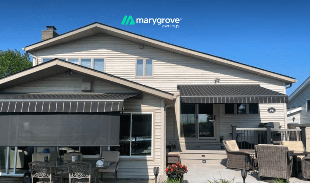 Marygrove Awnings retractable awnings shading a backyard patio and deck on a two-story home.