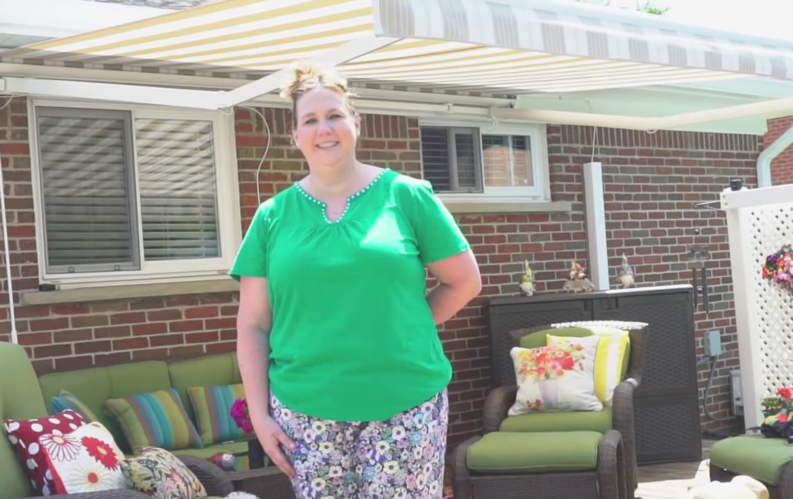 Customer standing on her patio beneath a retractable awning